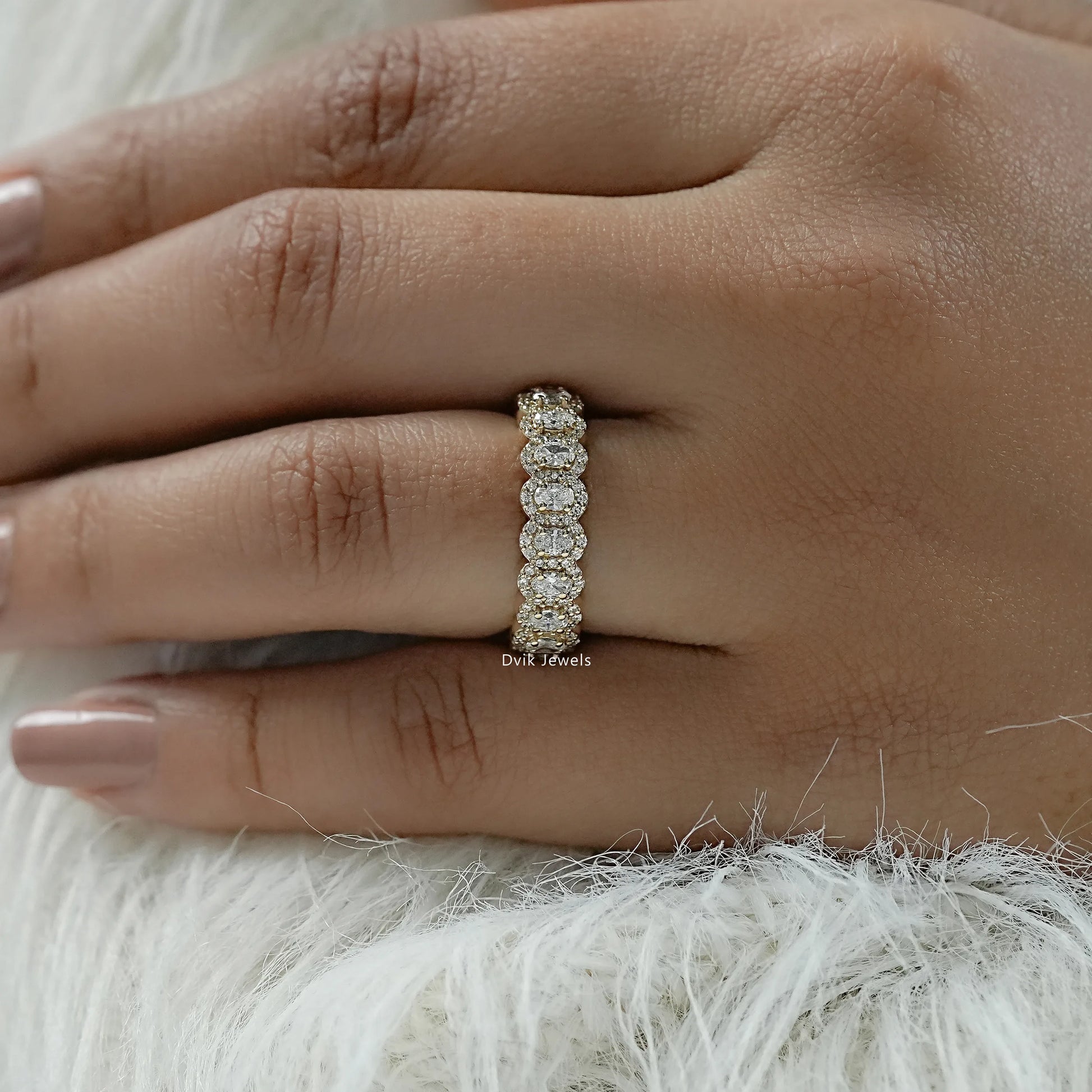 Oval cut diamond wedding band with a unique halo cluster design.