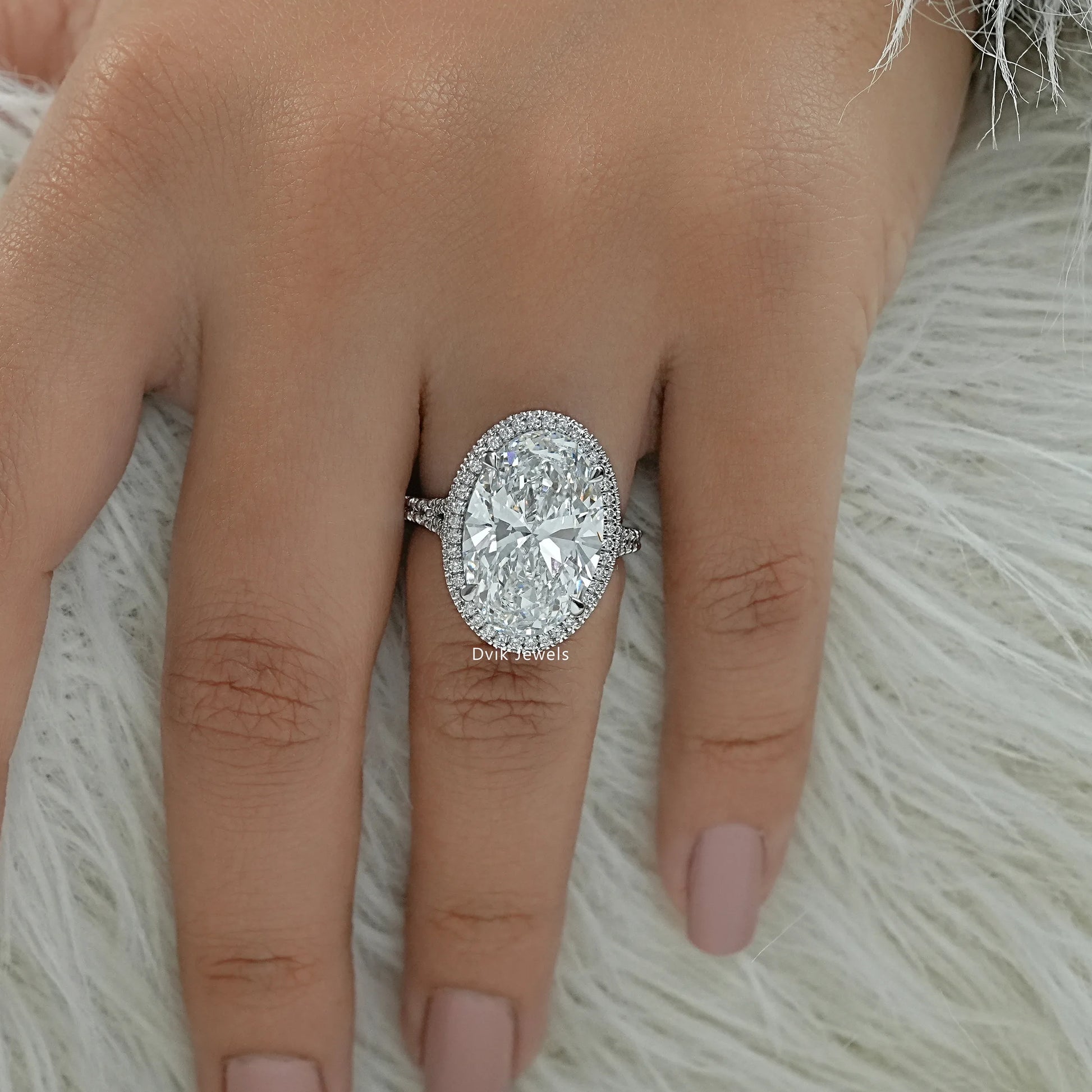 Halo engagement rings oval worn on a finger for a classic bridal display