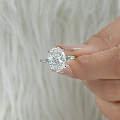 Inner shank view of a three diamond engagement ring showing the polished white gold finish.