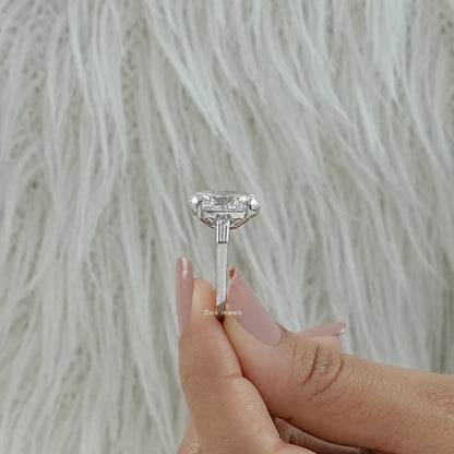 Oval lab diamond engagement ring with tapered baguettes profile view
