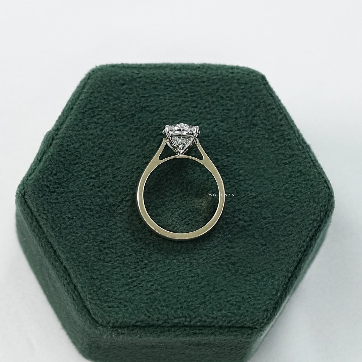 Side angle view of a 1 carat lab grown oval diamond ring displaying the elevated stone height.