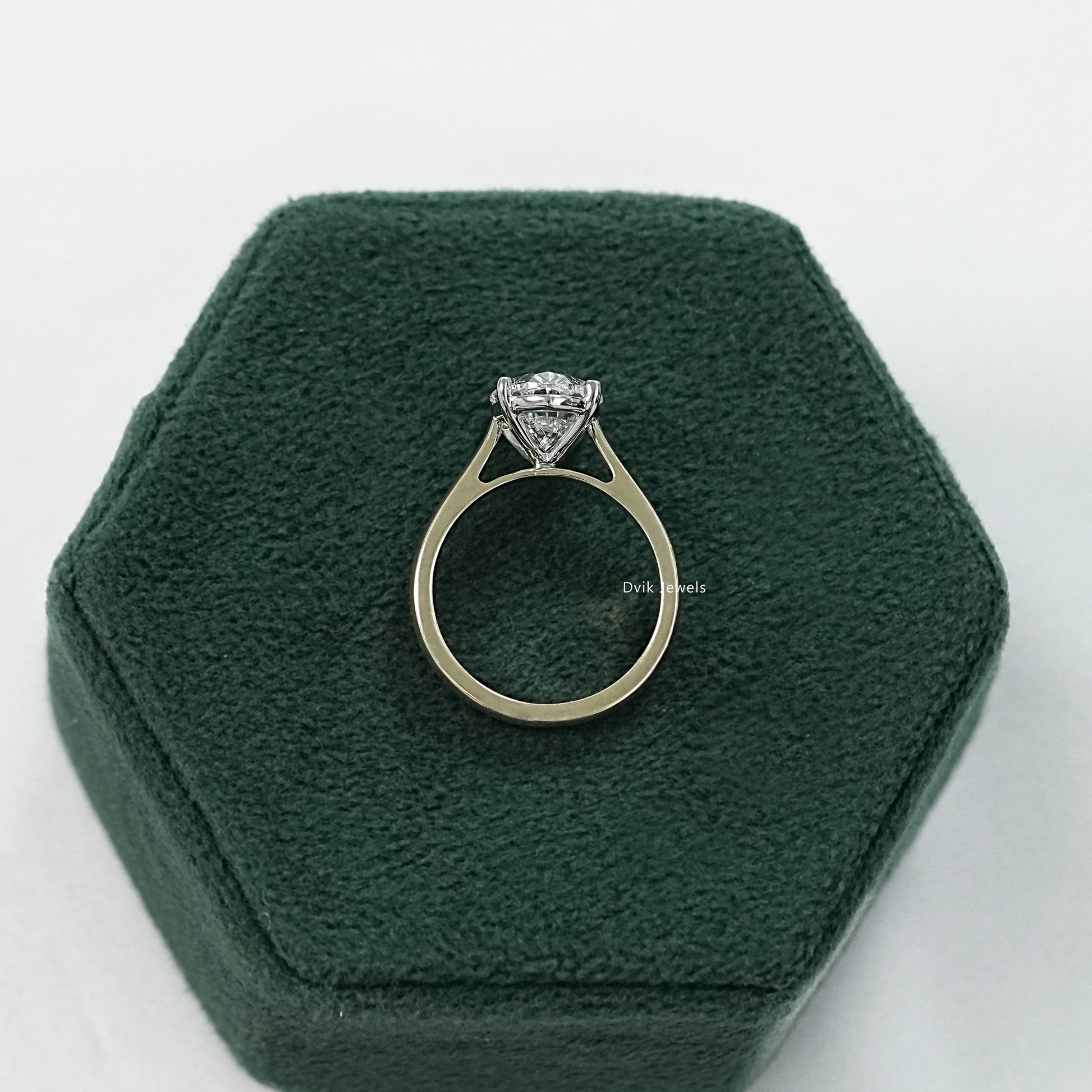 Side angle view of a 1 carat lab grown oval diamond ring displaying the elevated stone height.