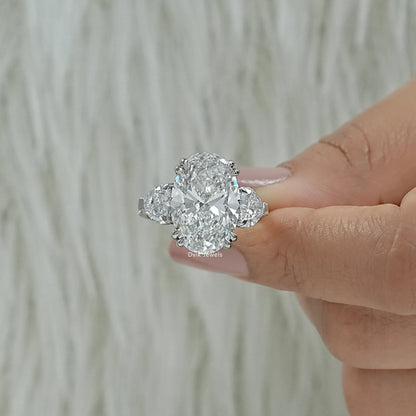 Double prong oval three stone ring oval diamond ring with side stones Finger view