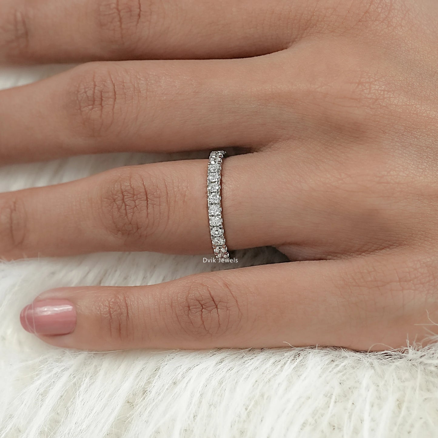 Delicate round cut half eternity band on model hand with pave setting