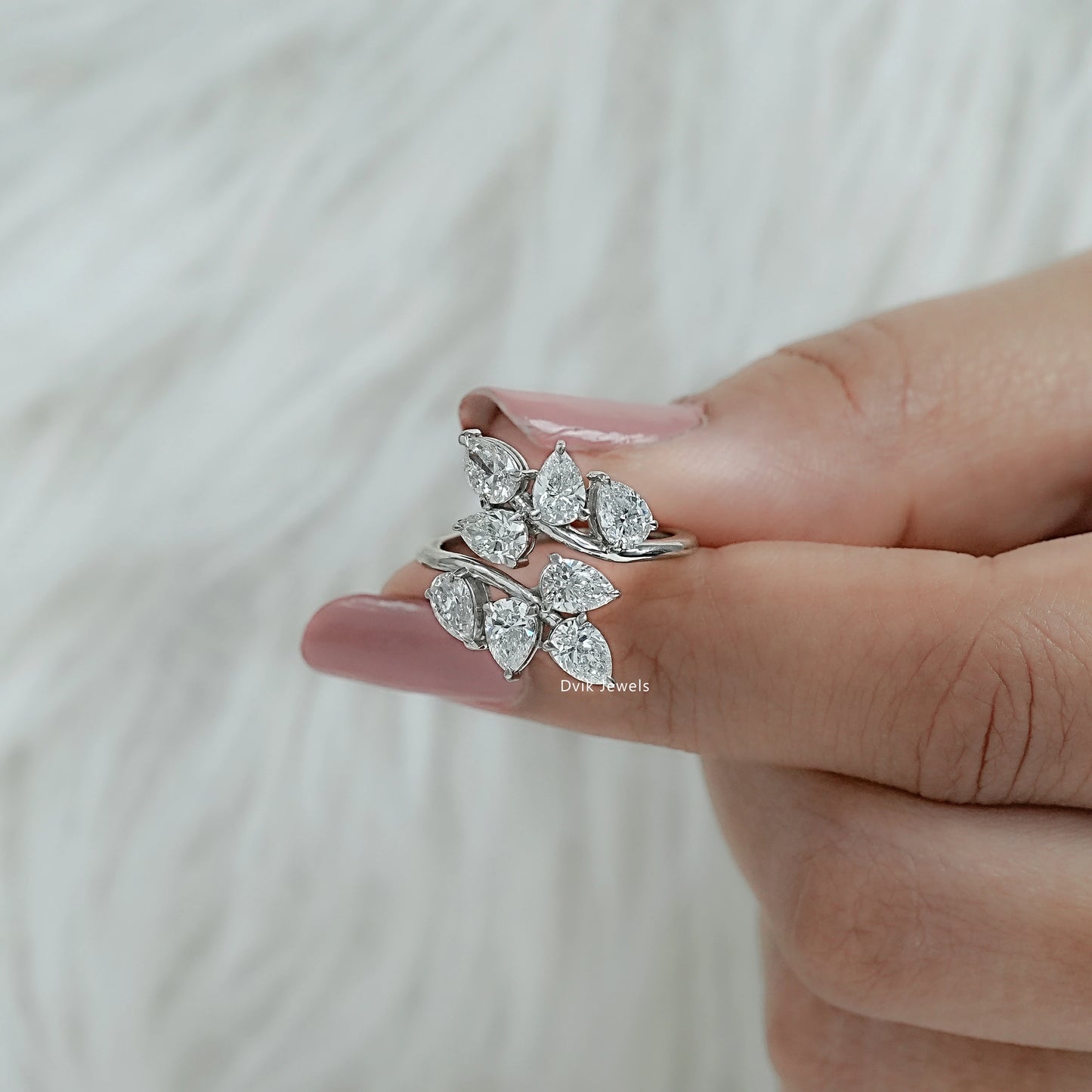 Two finger hold pear diamond engagement ring with bypass setting