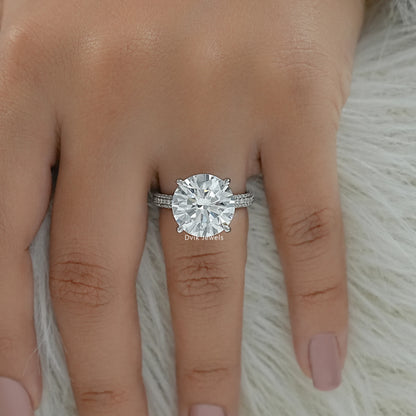 Round diamond ring with side stones on finger top view