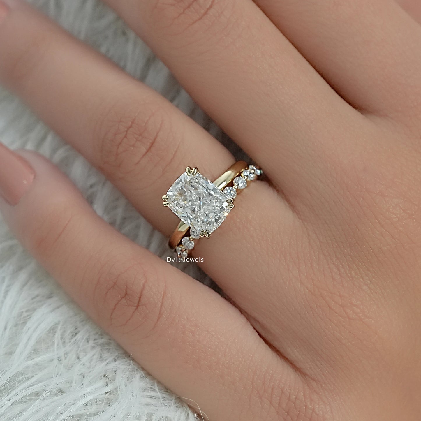 Bridal set rings featuring a cushion diamond and a shimmering diamond-set band.