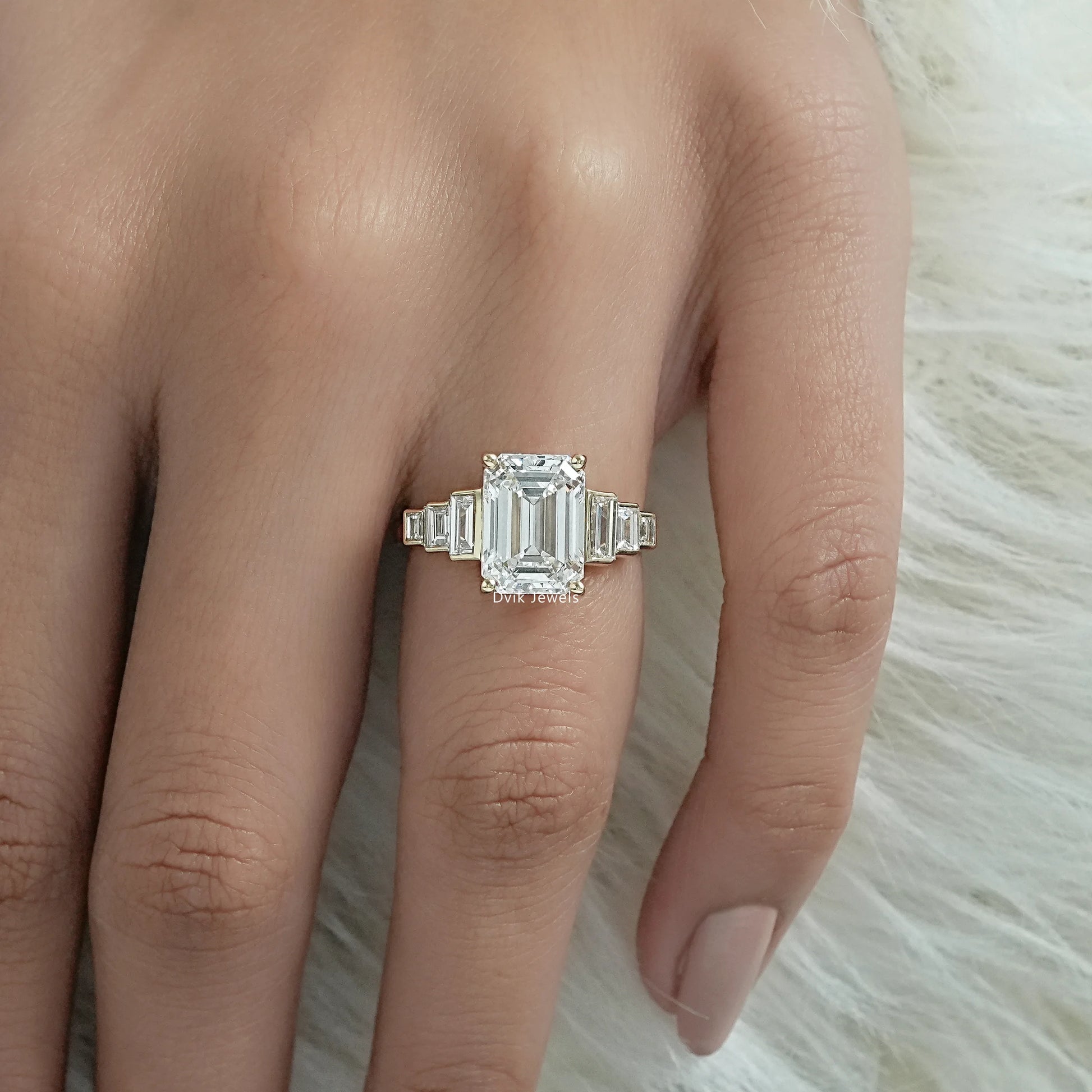 Emerald cut diamond ring with side stones worn as a luxury bridal set