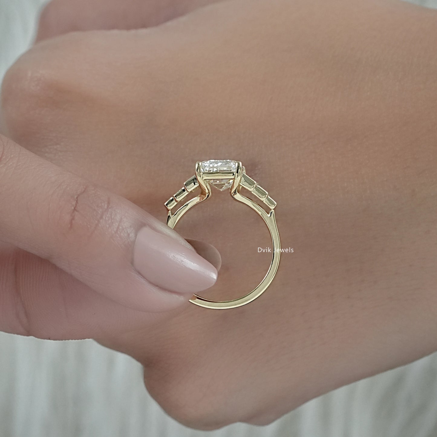 Emerald cut engagement rings with baguettes highlighting the side accents.