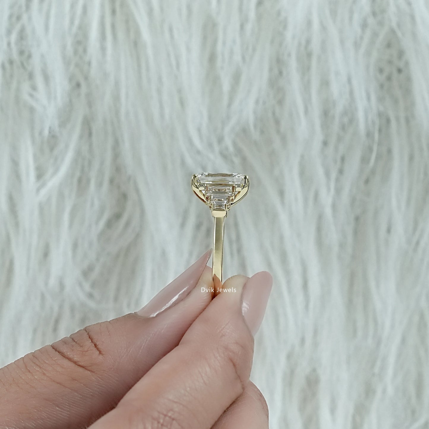 4 carat emerald cut engagement ring shown in a detailed close-up view.