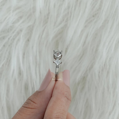 Bottom view of a five stone wedding band held between fingers showing the secure prong work.