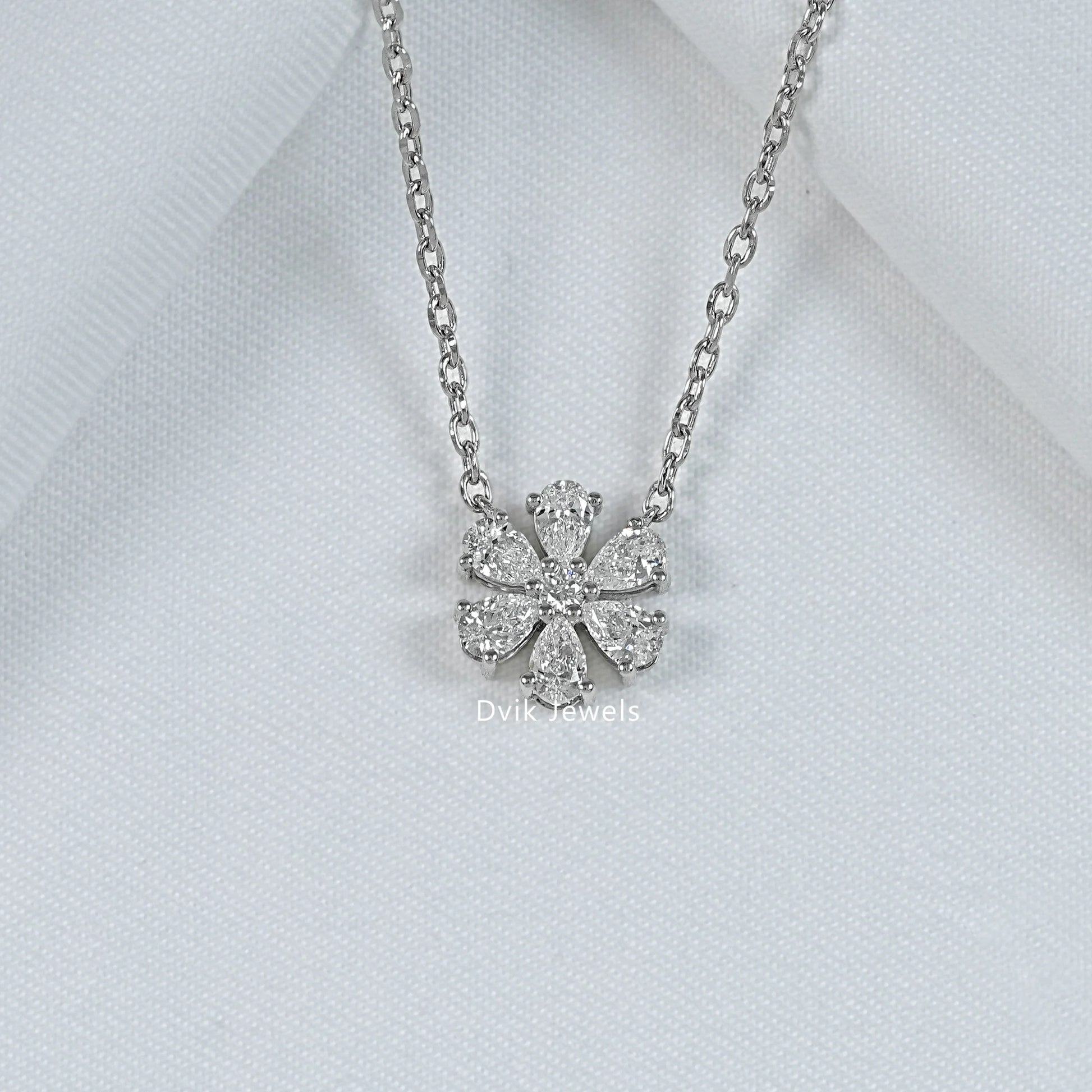 Pear and round lab diamond floral shape pendant display by Dvik Jewels