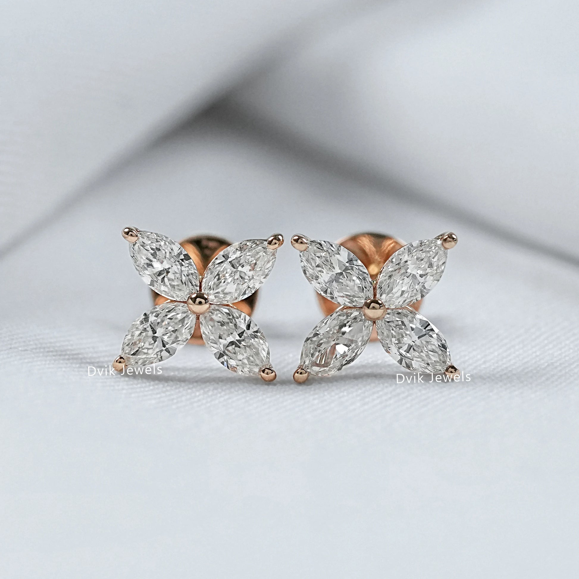 Back and front view of marquise diamond stud earrings showing the high-quality metal finish.