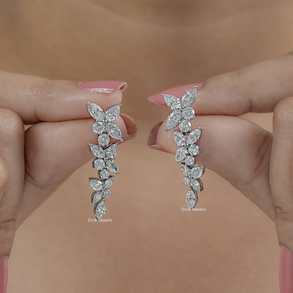 Cluster floral earrings with marquise lab grown diamond hold by women to show length