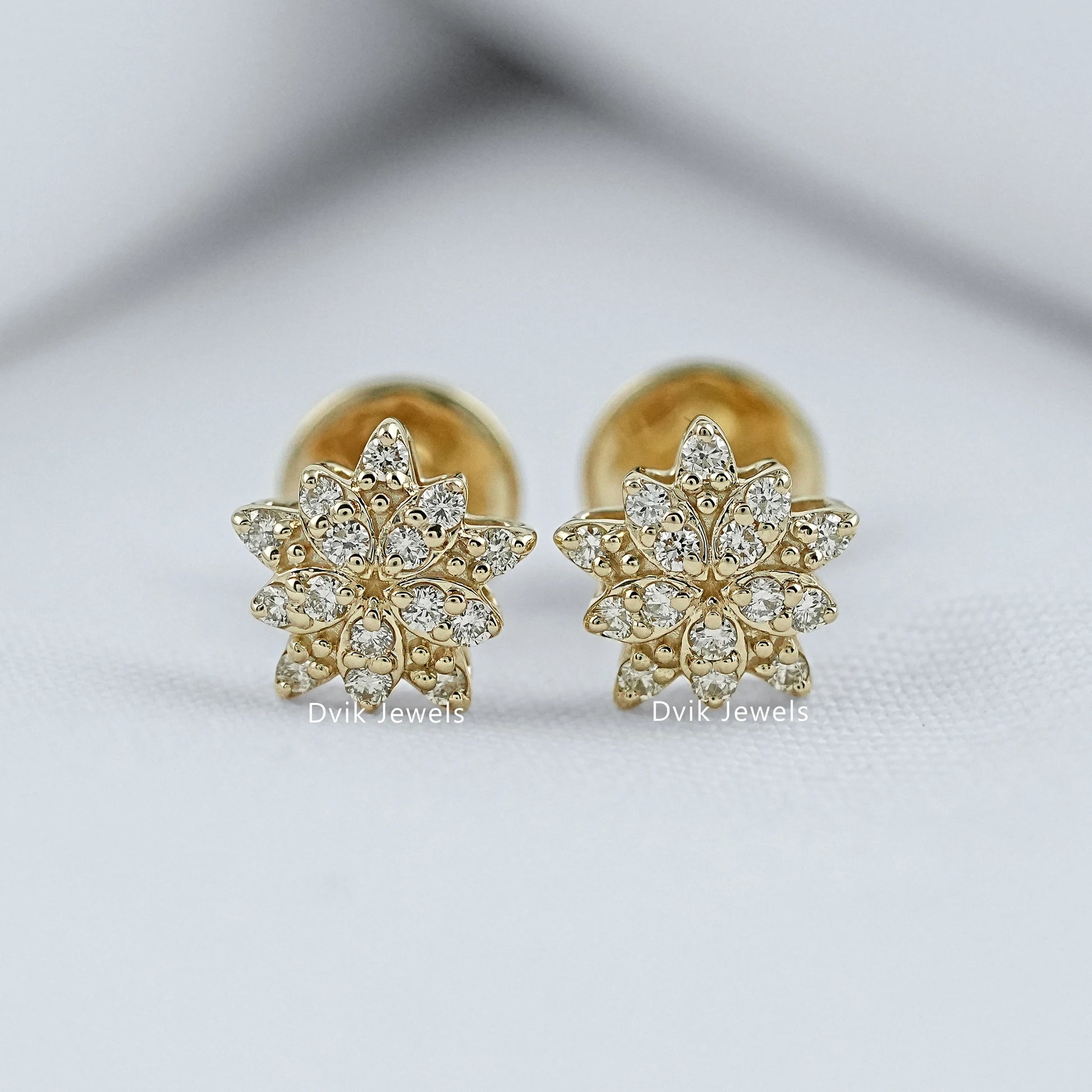 Close-up view of the round cut flower shaped earrings yellow gold for women