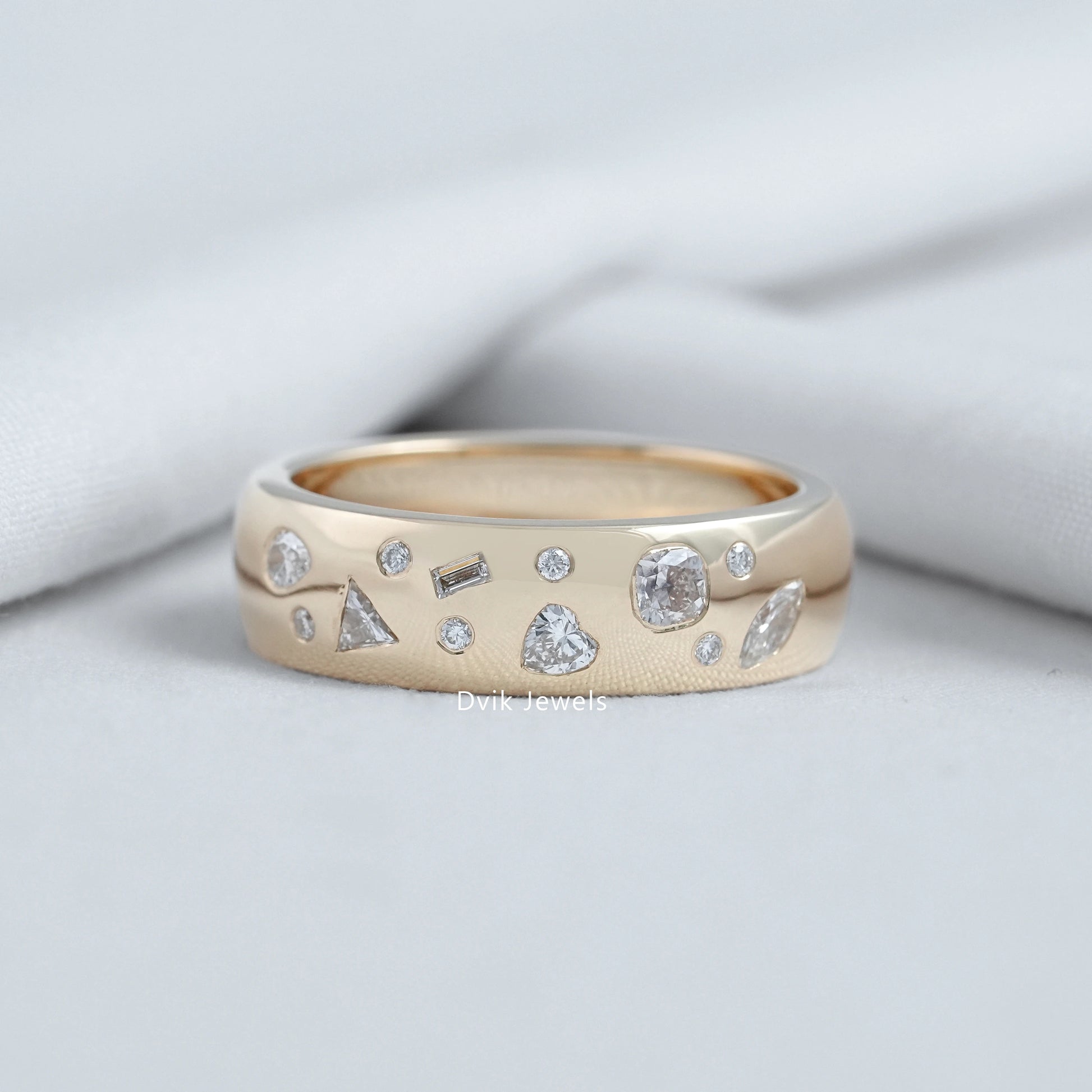 Multi Shape Scatter Band held to show the various lab diamond cuts on gold