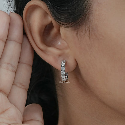 On-ear side view of small diamond hoops white gold displaying the secure hinged clicker closure.