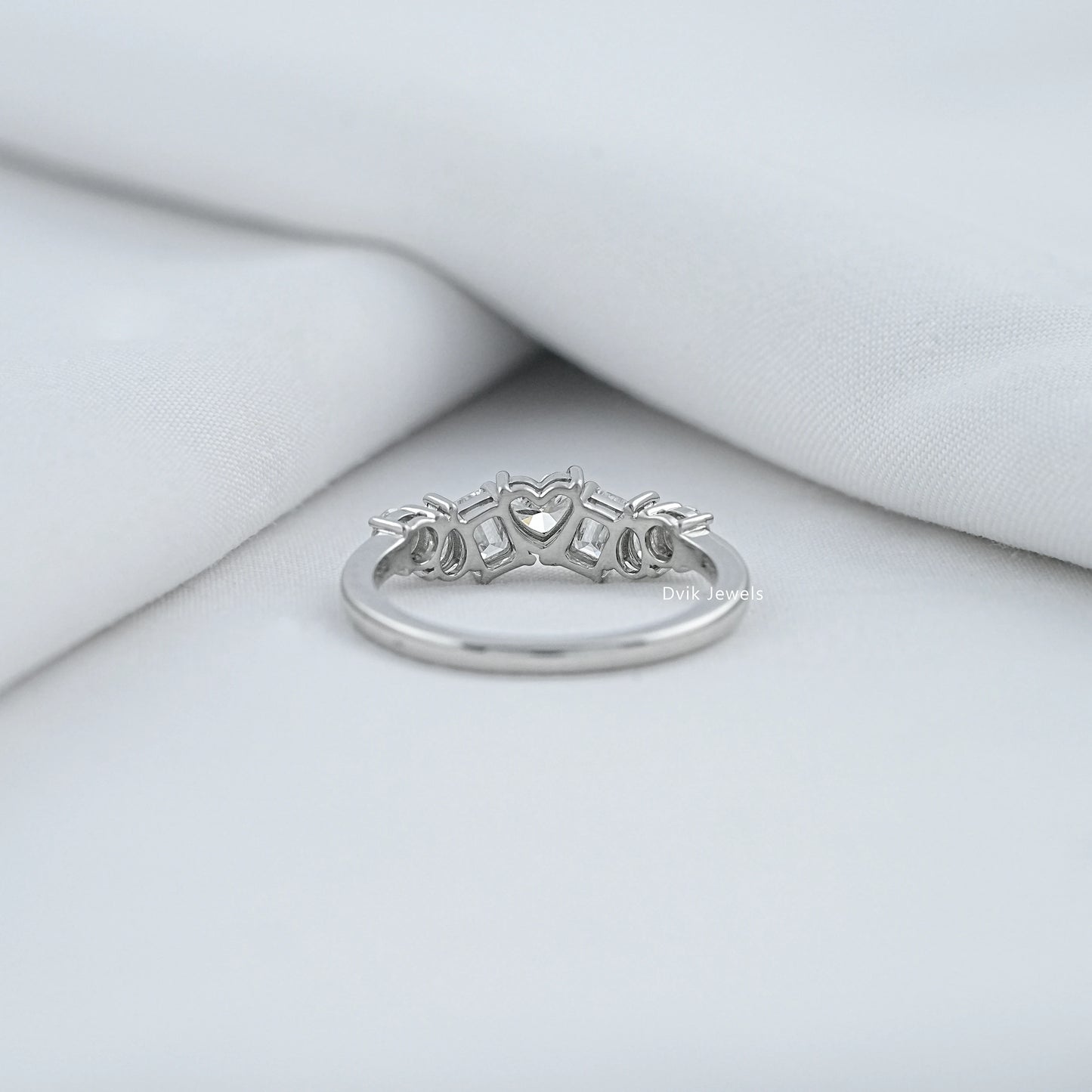 Back view of a mixed shape diamond eternity band showing the secure open-back setting.