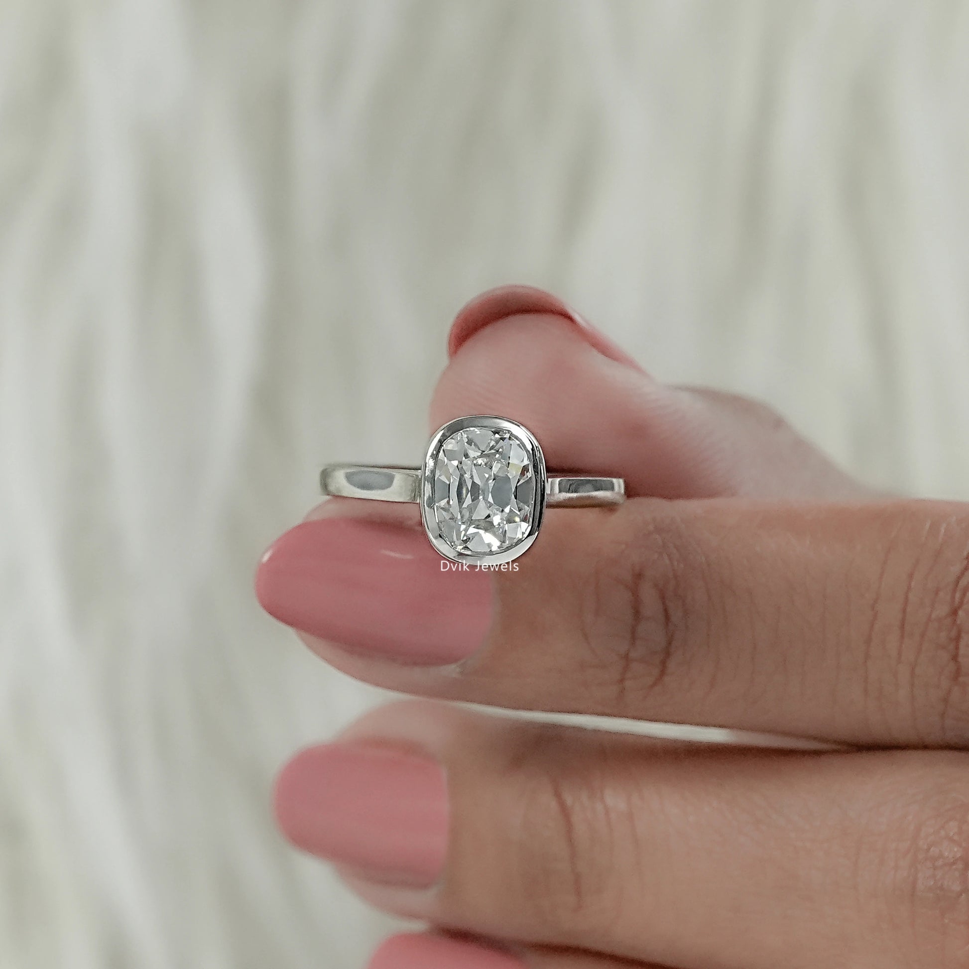 Front view of old mine cushion cut engagement ring highlighting the antique facets