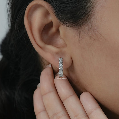 Detailed on-ear view of inside out diamond hoop earrings white gold featuring a modern prong set.
