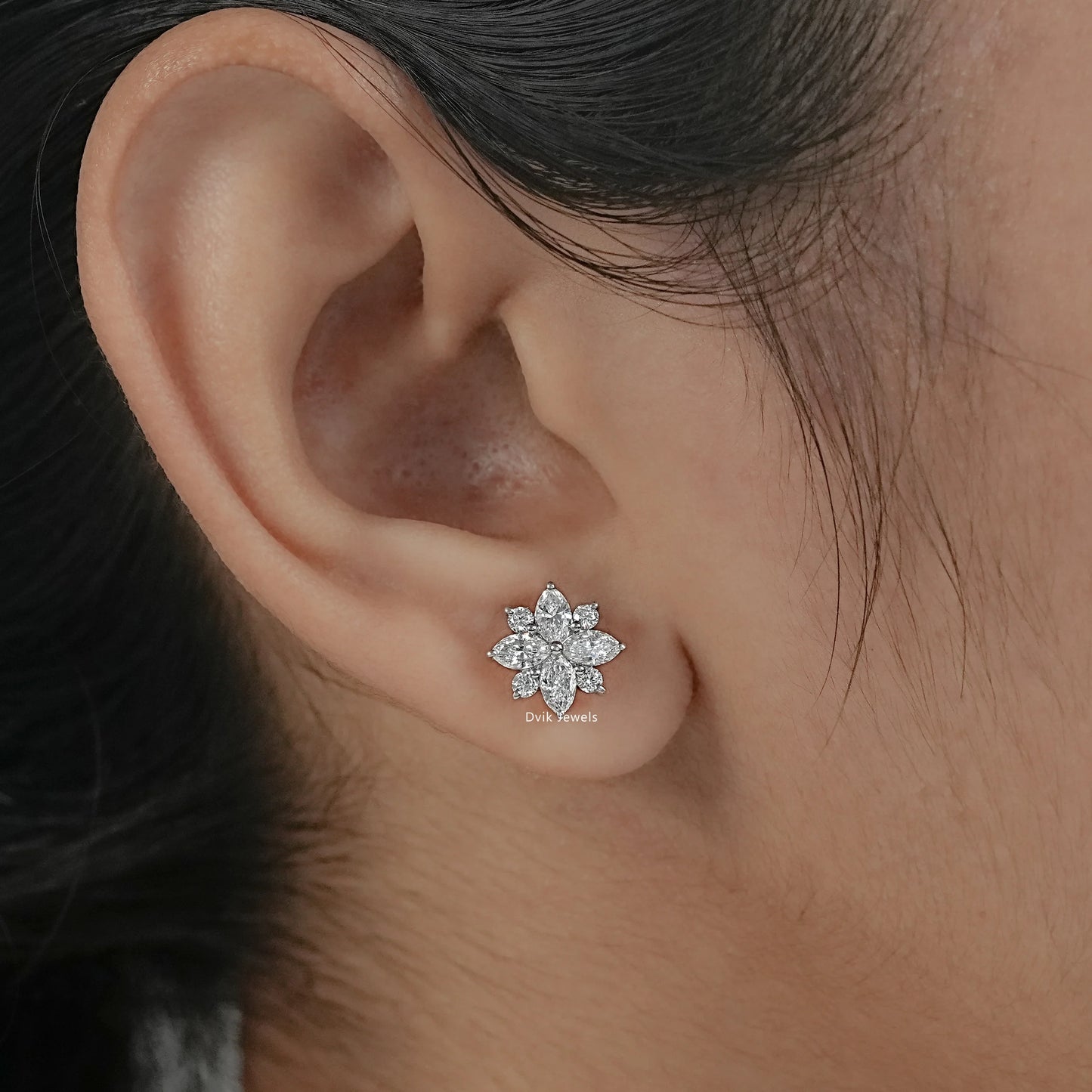 Marquise cut floral stud earrings with round brilliant diamond​ worn by women