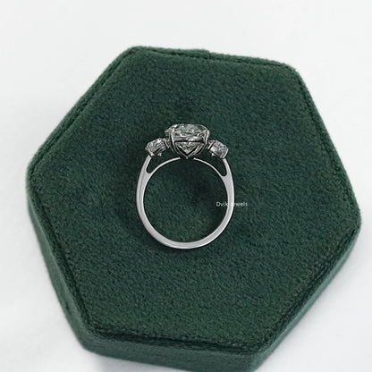 Engagement rings with half moon side stones on a clean white surface view