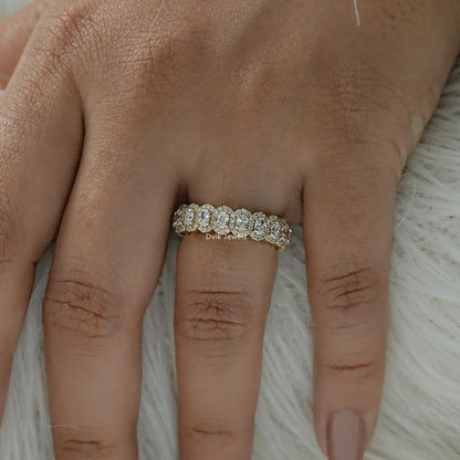 Oval halo eternity band worn as a luxury bridal diamond ring.
