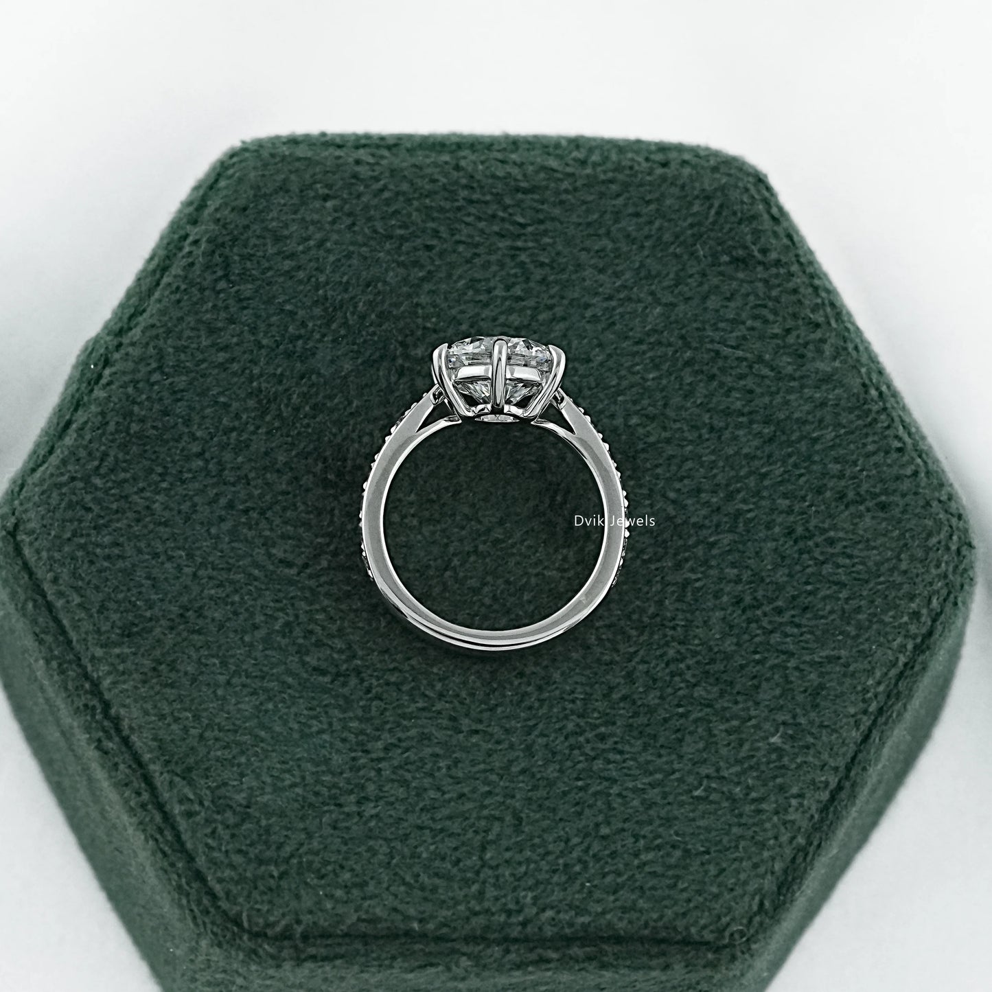 Pave set engagement ring featuring a solitaire vintage mine cut diamond