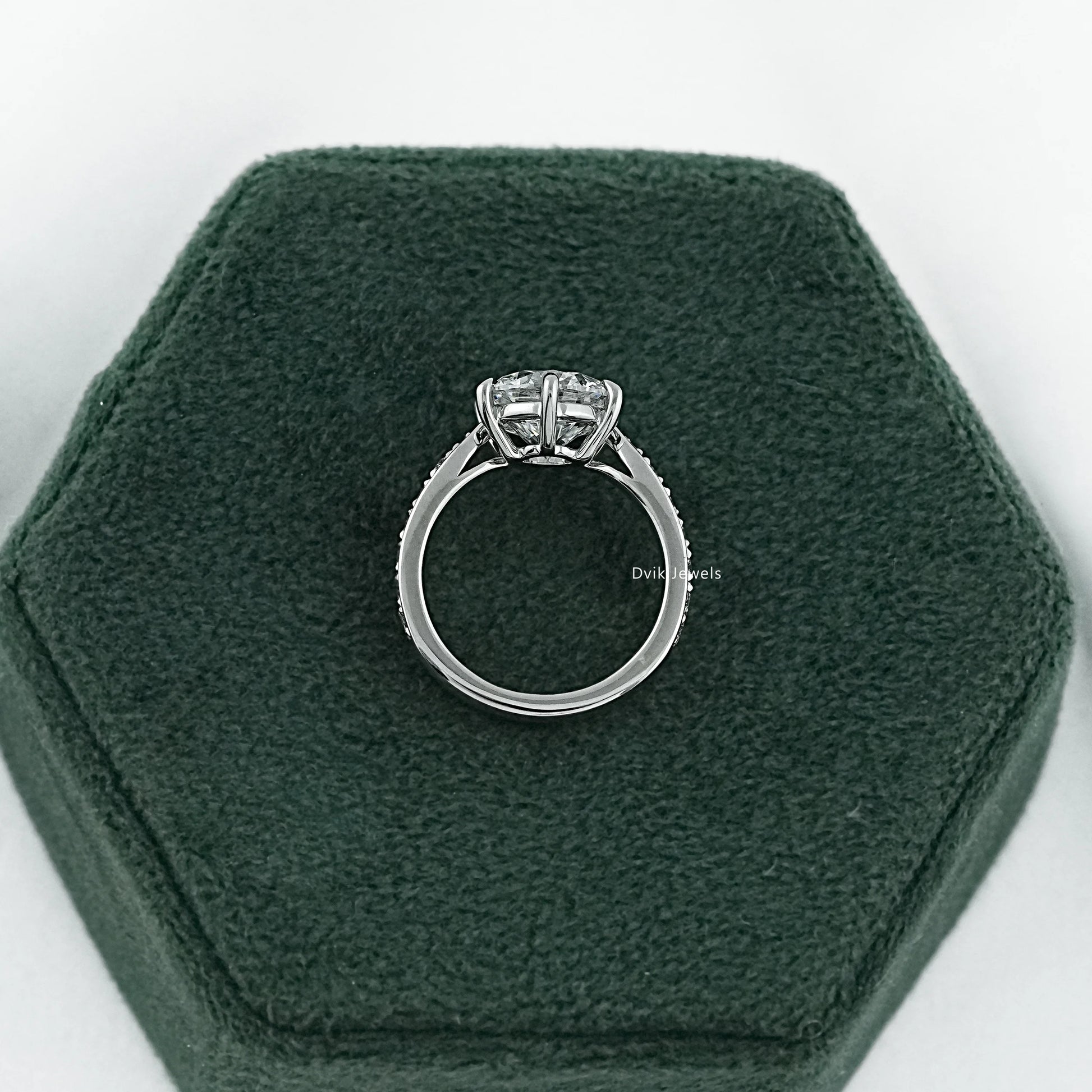 Pave set engagement ring featuring a solitaire vintage mine cut diamond