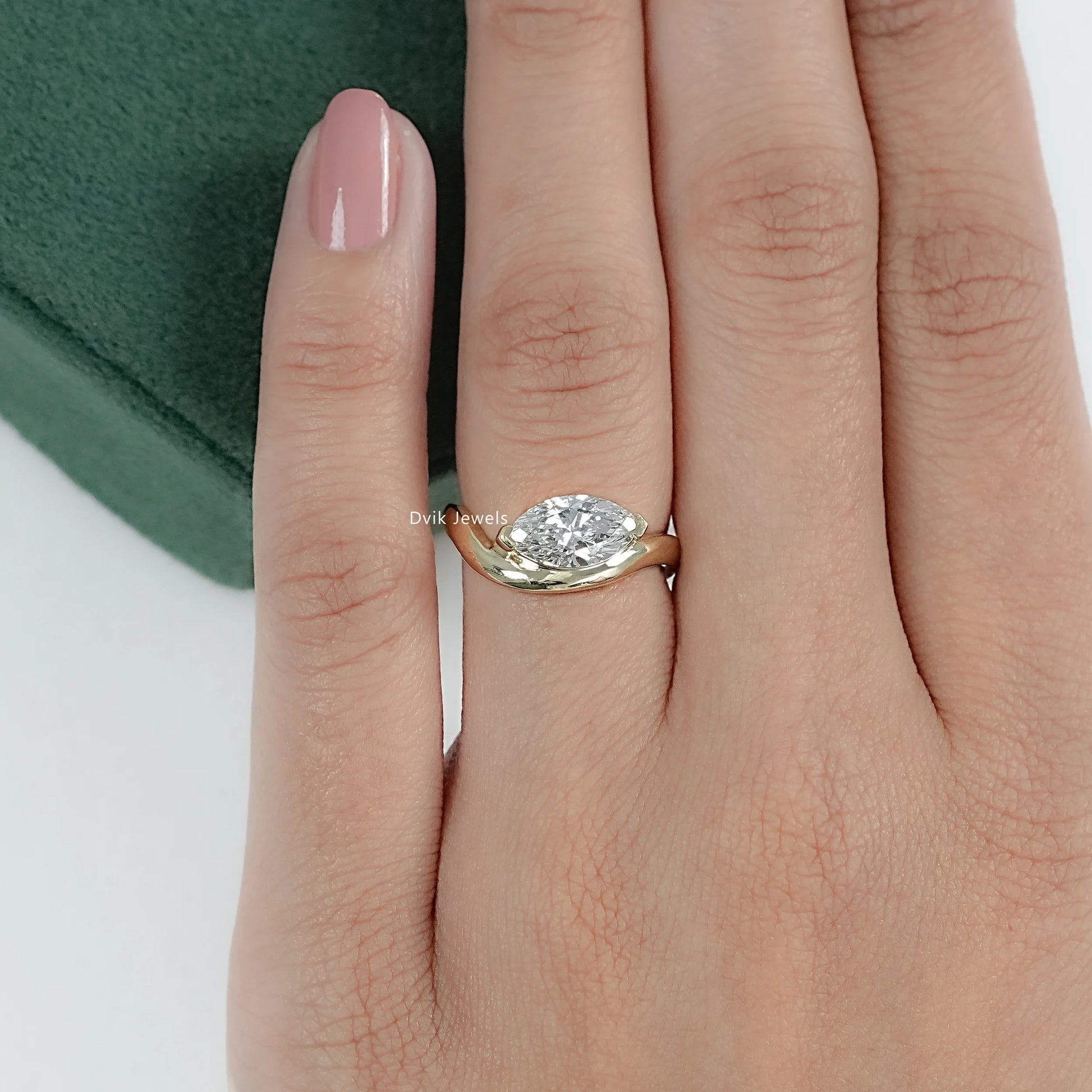 Curved Marquise Cut Solitaire Engagement Ring styled on hand reflecting minimalist design