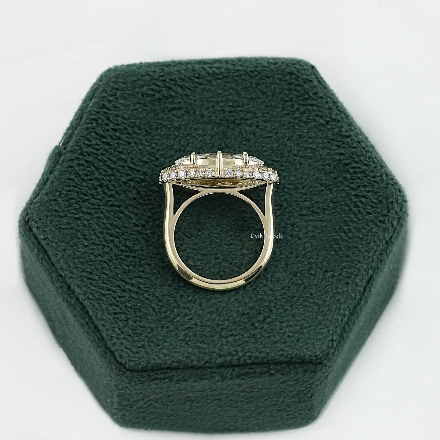Side profile of marquise diamond engagement ring showing pave-set bridge and the secure six-prong setting
