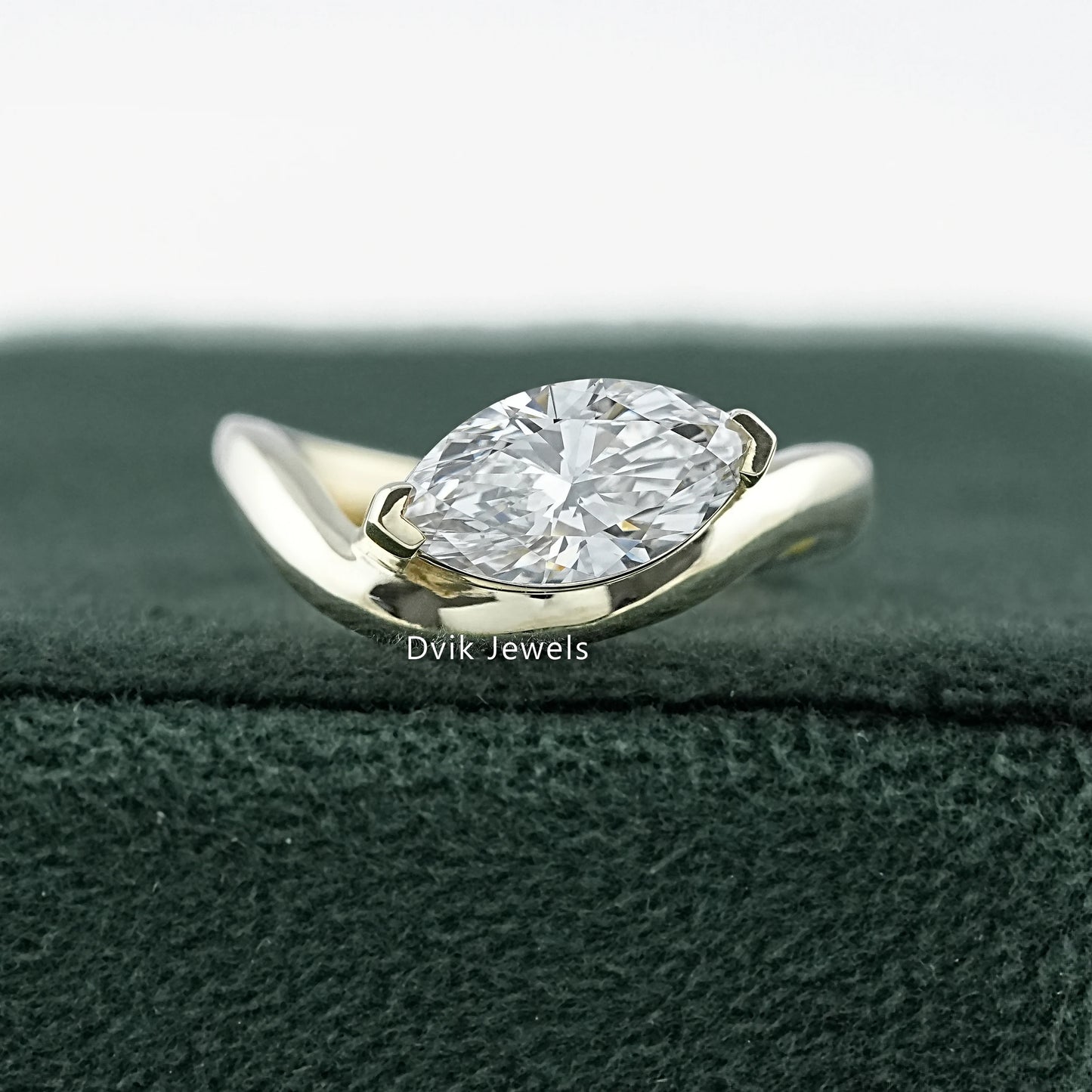 Curved Marquise Cut Lab Diamond Solitaire Engagement Ring featuring sleek gold band by Dvik Jewels