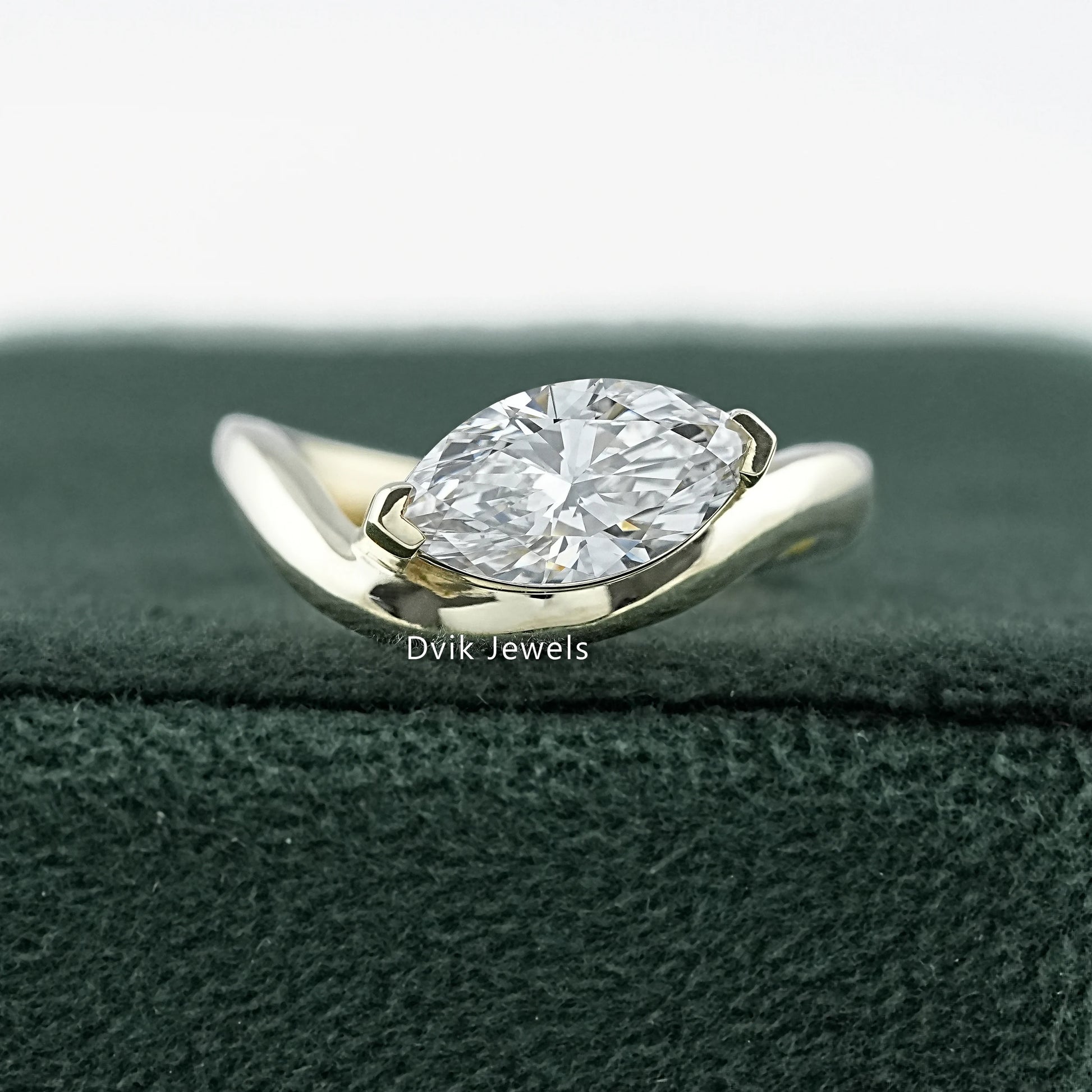 Curved Marquise Cut Lab Diamond Solitaire Engagement Ring featuring sleek gold band by Dvik Jewels