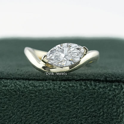 Curved Marquise Cut Lab Diamond Solitaire Engagement Ring featuring sleek gold band by Dvik Jewels