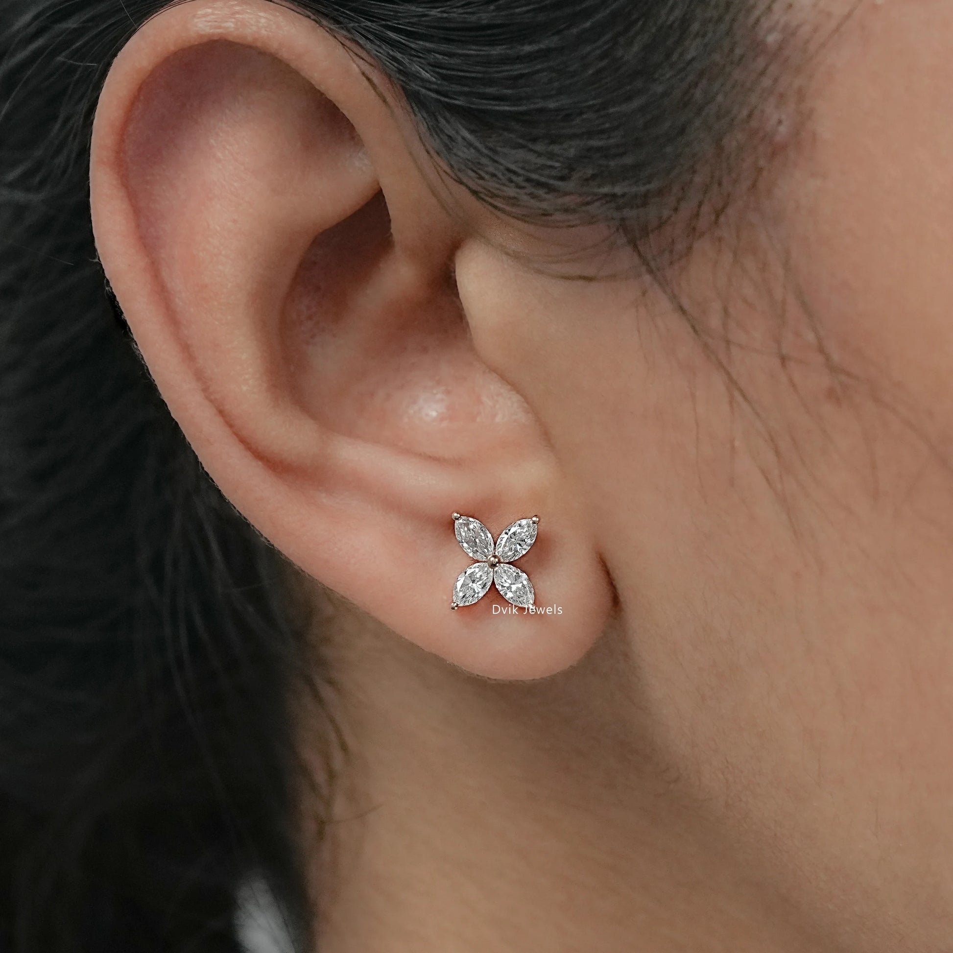 On-ear front view of floral diamond stud earrings for women in USA, showing a stylish ear fit.