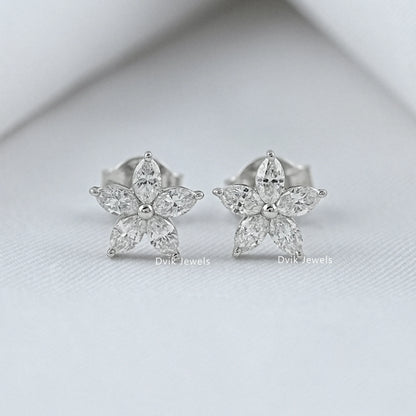 Front view of diamond flower earrings in silver and white gold