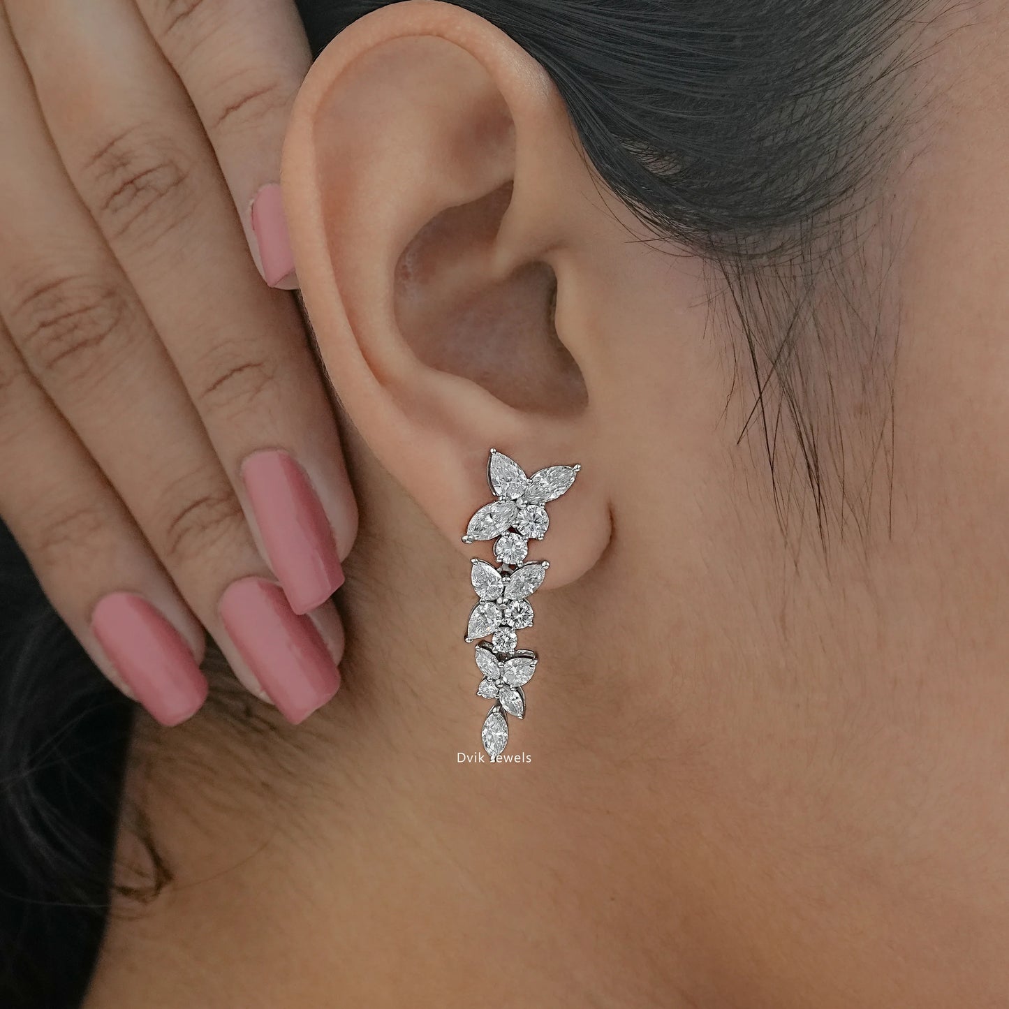 Elegant diamond drop earrings wear by model, highlighting the marquise-cut stones