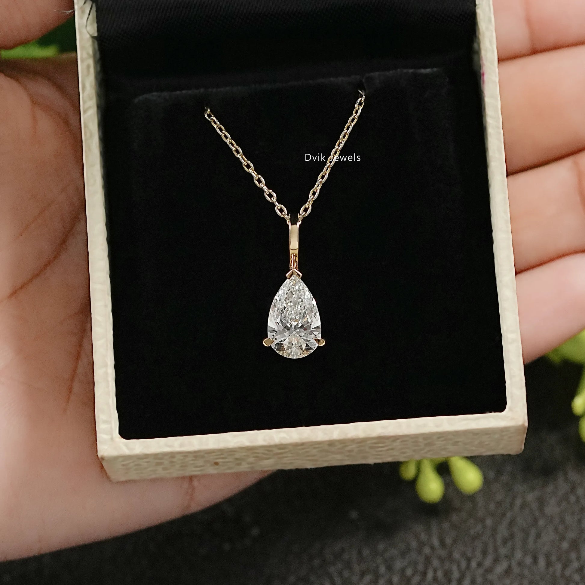 Front view of pear diamond pendant presented in a premium jewelry box
