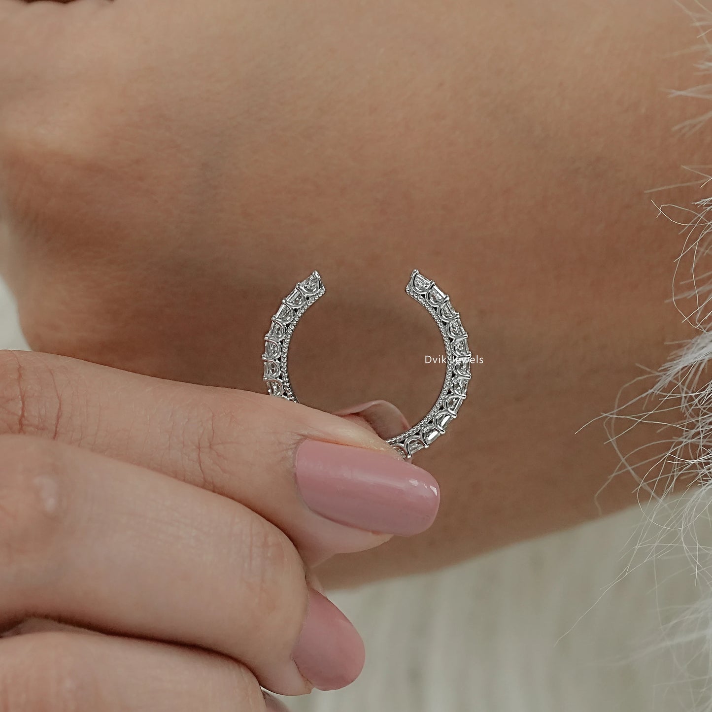 Princess cut wedding band with open cuff style hold by women to show high-polish metal