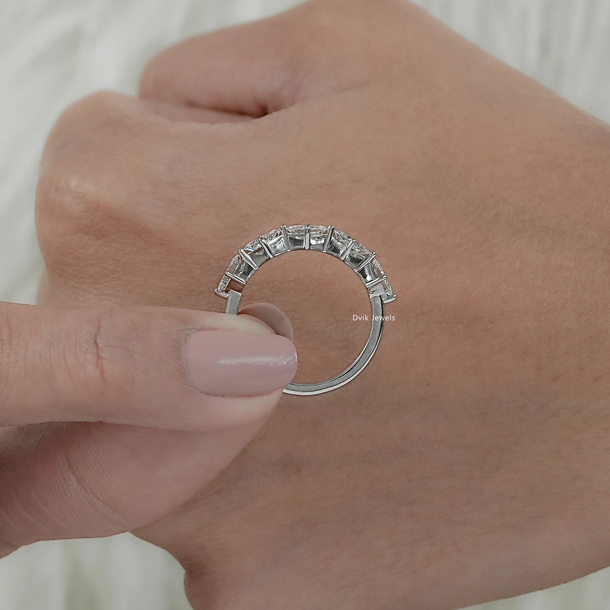 Cross-section view of a lab diamond princess cut eternity band highlighting the kite-set row.