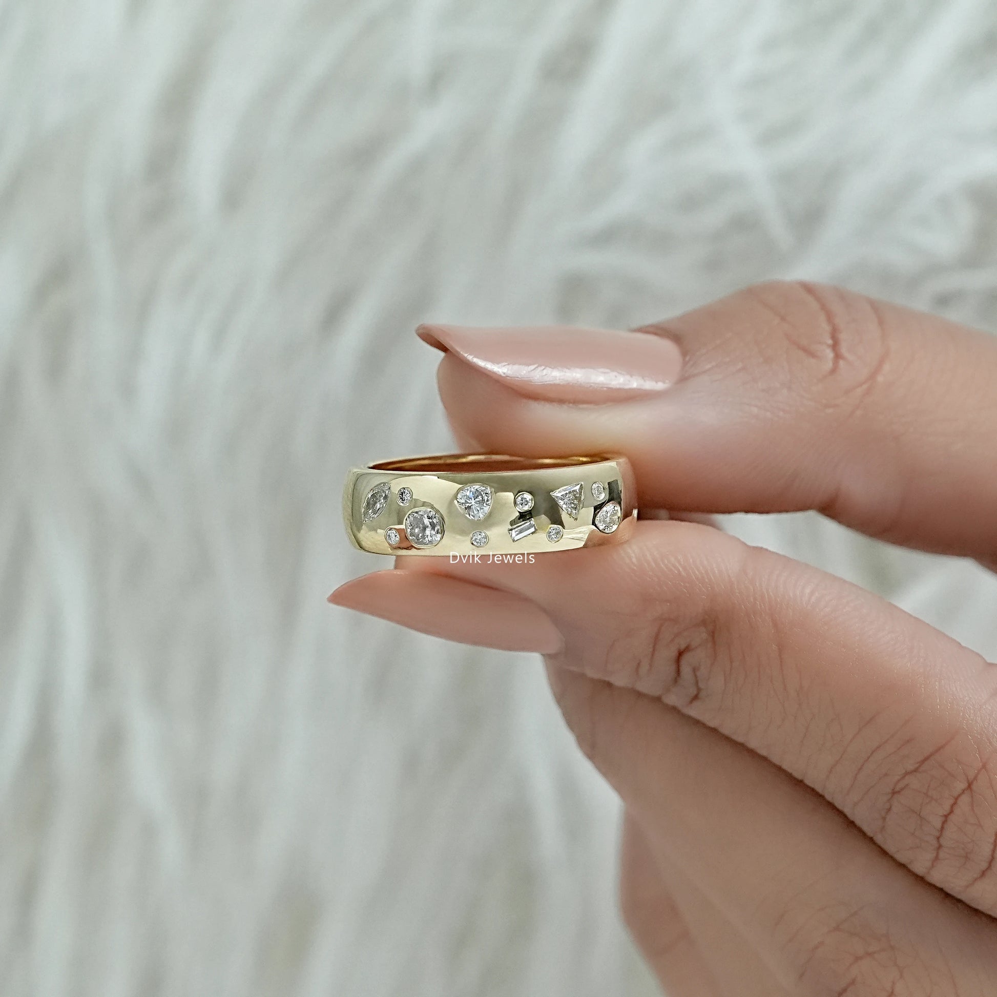 Gypsy style engagement ring held to highlight the secure metal craftsmanship