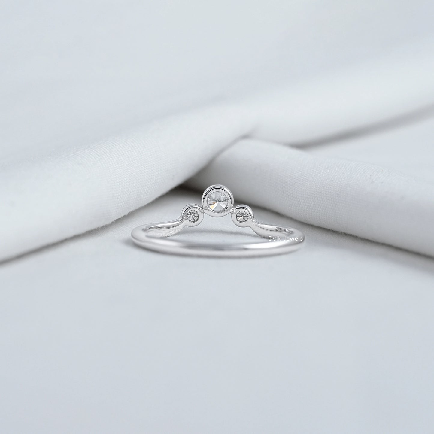 Curved bezel trilogy rings with sparkling lab diamonds in white gold.