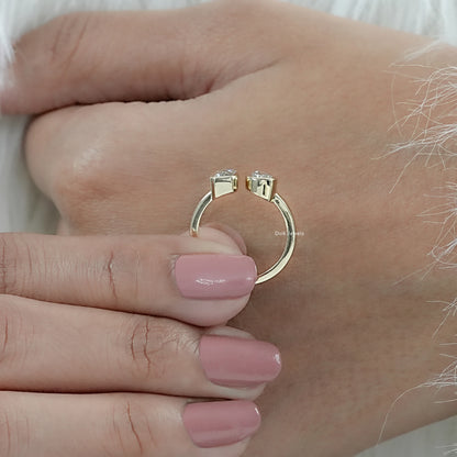 Emerald and Pear Cut Bezel Set Lab Diamond Toi Moi Ring held vertically by woman showing twin stones