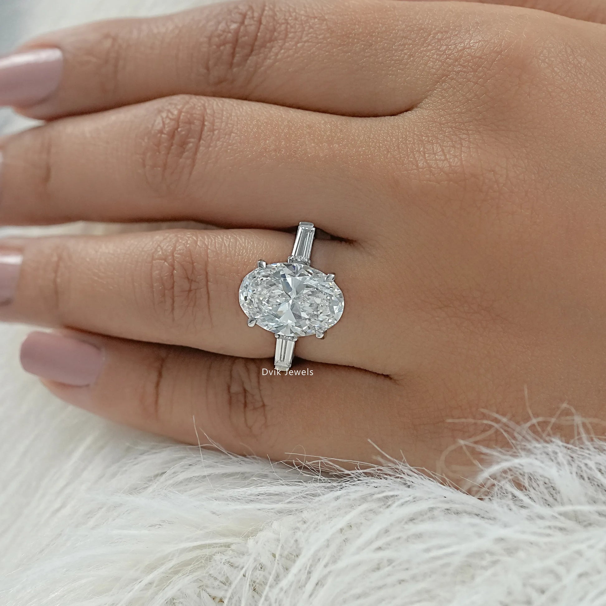 Engagement ring oval with side stones shown on hand top view