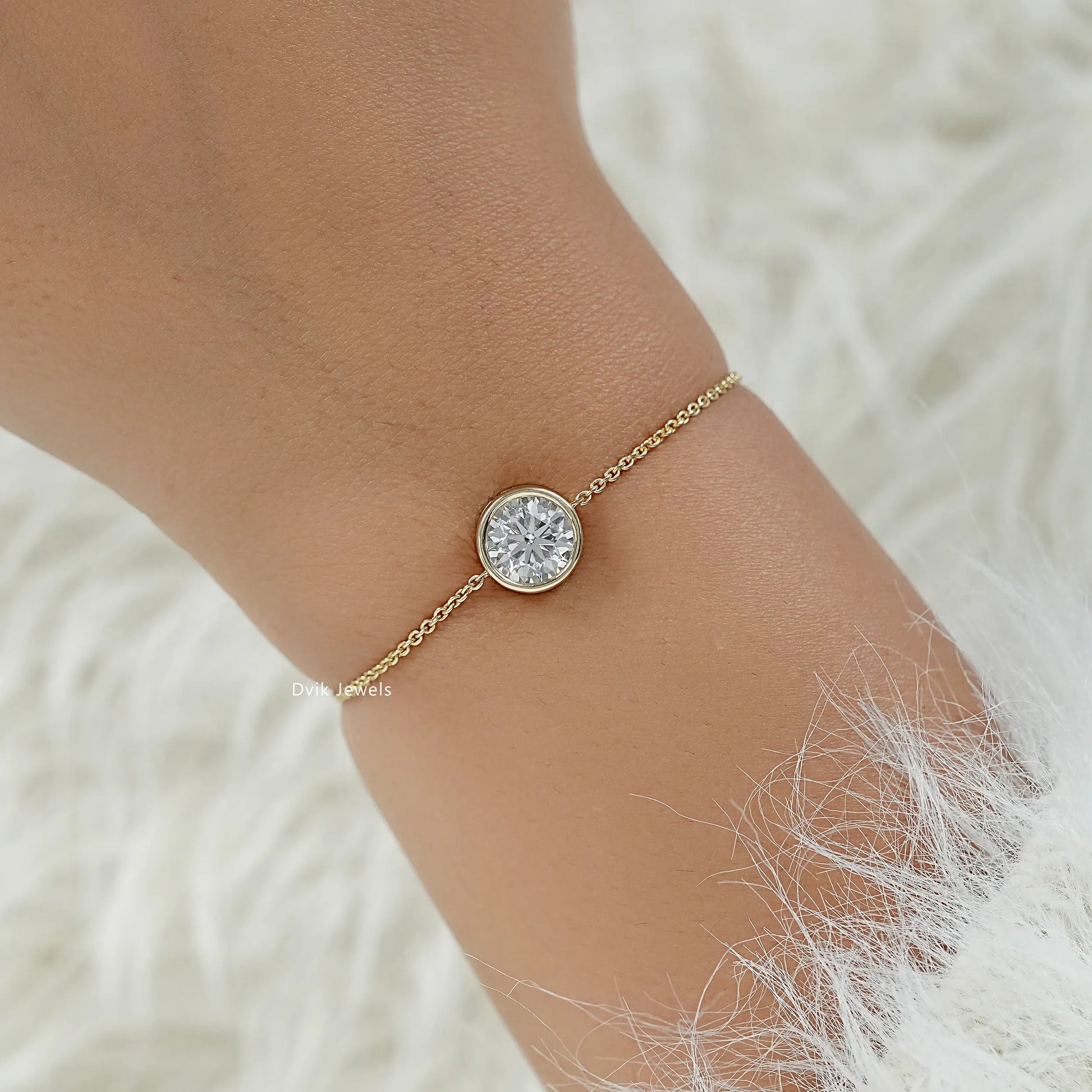 Round diamond bracelet chain yellow gold on wrist top view