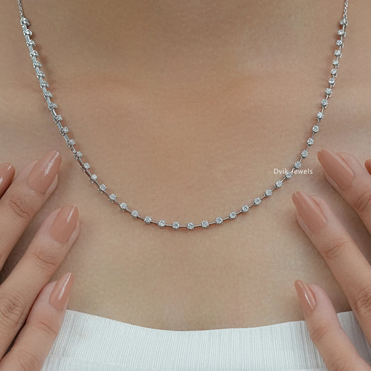 Round cut diamond necklace shown in a detailed close-up on a soft fabric