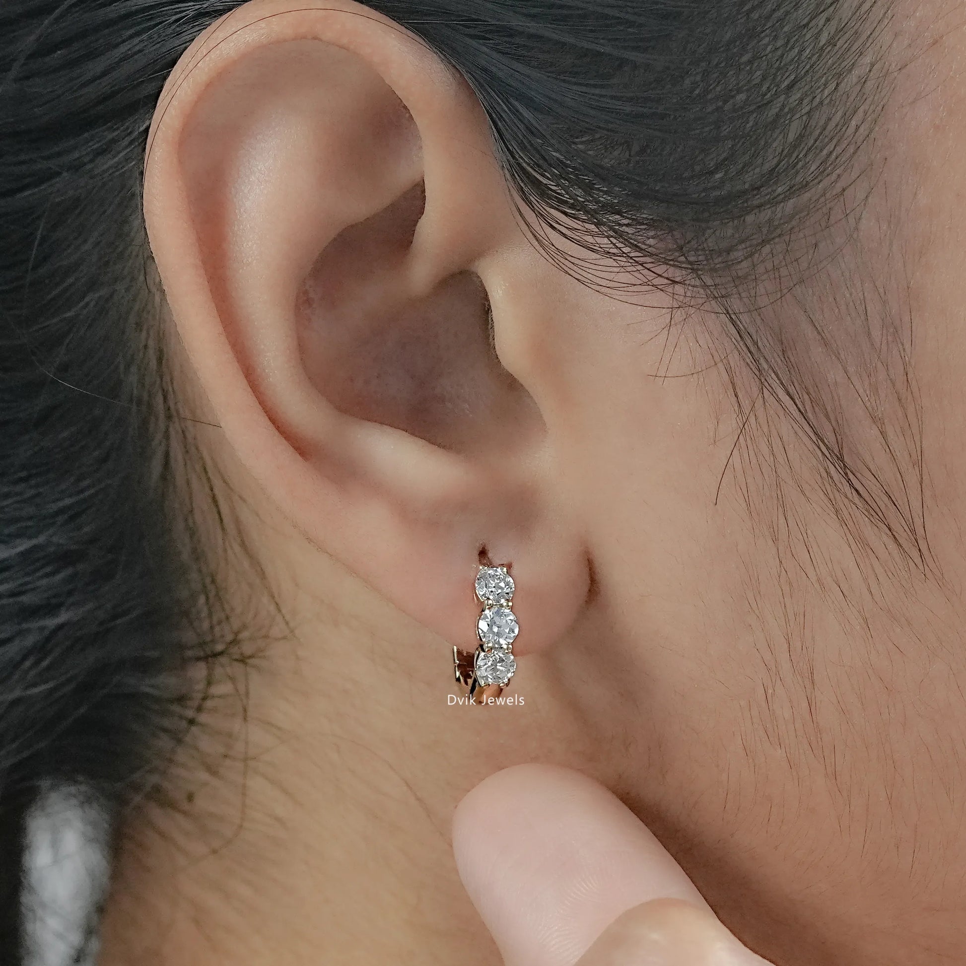 Minimal round cut hoop earrings with lab made diamond on model ear