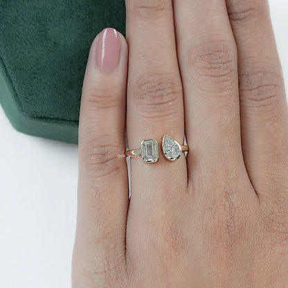 Lab Grown Diamond Bezel Set Toi Moi Ring with Emerald and Pear Cuts showcased on model hand