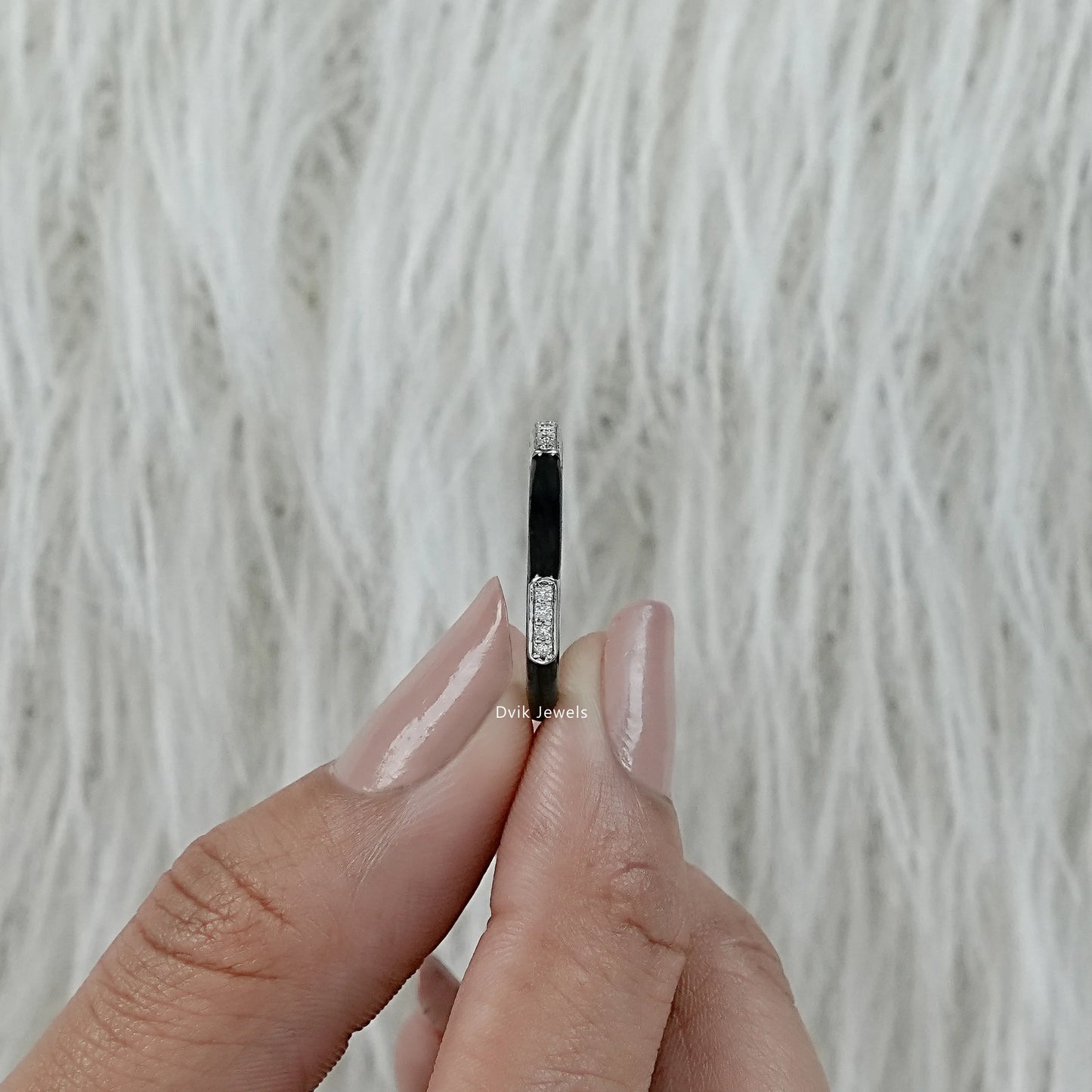 Black enamel wedding band white gold diamond bar held in hand