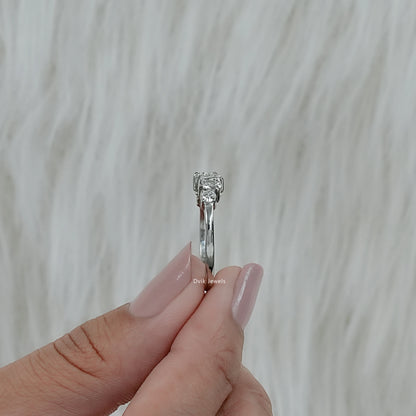 Side view of women's diamond anniversary bands held between fingers to show the ring's height.